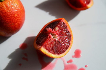 Blood orange on light marble background. Tasty red citrus fruit. Vitamin C concept. Organic food