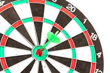 Dartboard with darts on white background, closeup. Purpose concept