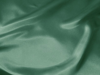 Shiny mint green crumpled fabric. Fluid wavy background. 