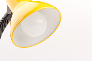 Yellow desk lamp isolated on yellow  background
