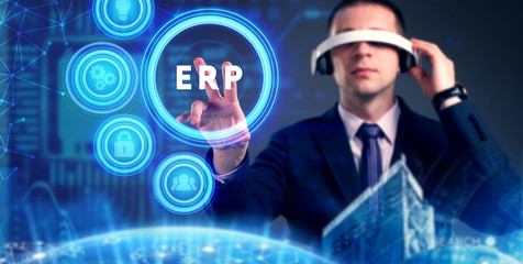Business, Technology, Internet and network concept. Young businessman working on a virtual screen of the future and sees the inscription: ERP