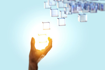 Hand holding glowing cubes. Innovation and creativity concept. © Sergey Nivens
