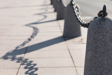Road fencing Granite posts with a large iron chain