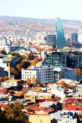 Obraz premium TBILISI, GEORGIA December 17, 2019: Beautiful aerial view of the old part of city with modern buildings in Tbilisi, Georgia