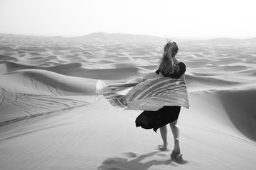 Photoshoot of a caucasian girl in the desert. Photoshoot of a caucasian girl in the desert. Black and white image