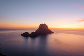 Fototapeta na wymiar Es Vedra at the sunset, pastel colored sky at the mystic rock of Es Vedra, Ibiza Island.