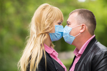 couple in love kisses mask, coronavirus, isolation
