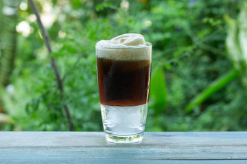 Root beer float a tasty summer treat on Green tree background