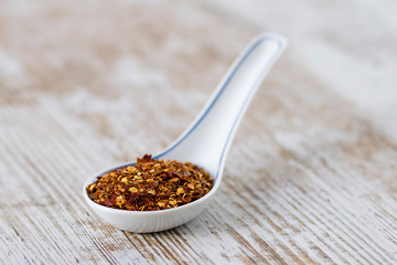Spices and herbs in porcelain spoons