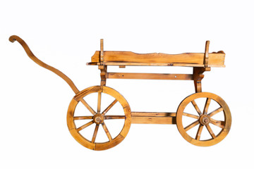 Fototapeta premium Wooden rustic four-wheel cart . onion in wooden cart bags . Wagon wood. Ancient cargo carriage against a red wooden background . Conservative ancient wagon on white background .