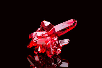 crystal of natural origin. close up of crystals in ruby color on black background