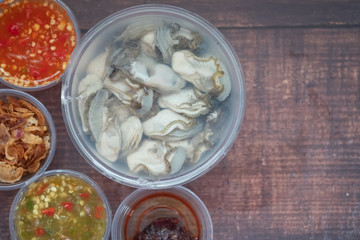 Raw oyster and side dishes in box in Thai style