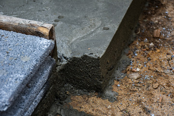 Wet cement corner of the foundation base of house maintenance at a construction site waiting to dry then continue with bricklaying work