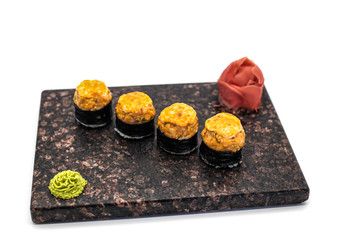 Hot sushi with wasabi and ginger in soy sauce on a white background