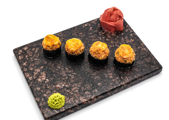 Hot sushi with wasabi and ginger in soy sauce on a white background