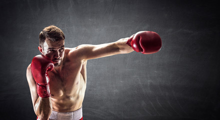 Fototapeta na wymiar Punch of professional young boxer