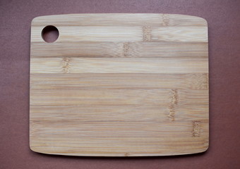 Wooden cutting Board on a brown background