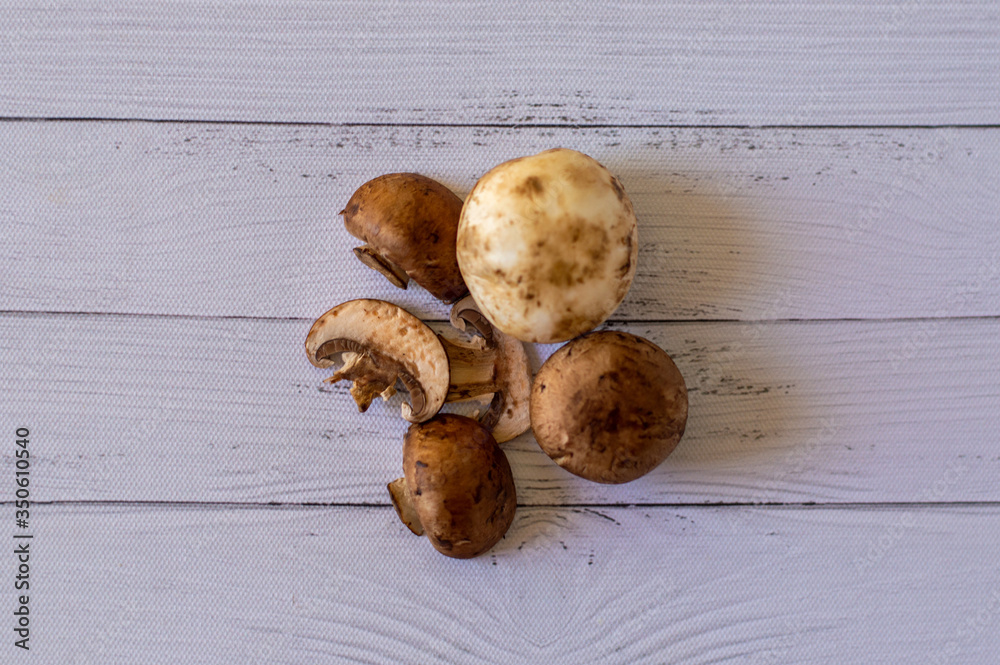 Wall mural big mushrooms on top of white rustic wood