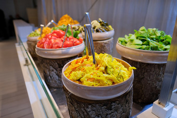 Various kinds of salads on white ceramic plates