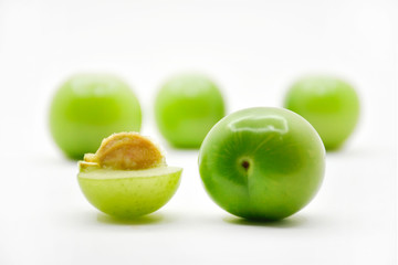 Green plum fruit isolated on white background