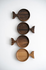 Round wood plate for food or snacks. Handmade hardwood new wooden cutting board isolated on white background. flat lay. Top view.