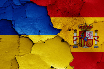 flags of Ukraine and Spain painted on cracked wall