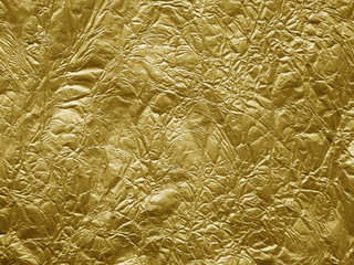 Gold metallic crumpled foil texture background