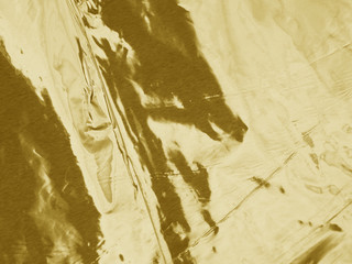 Gold metallic crumpled foil texture background