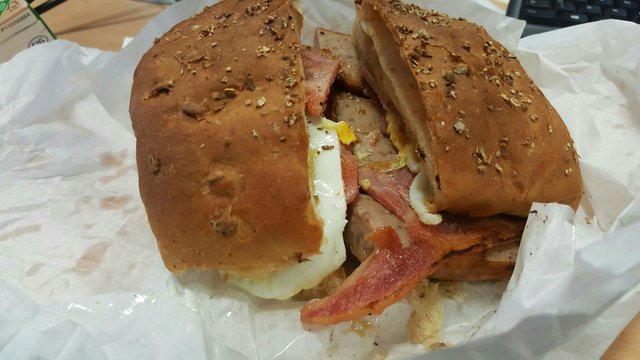 Close Up Of Burger Wrapped In Paper