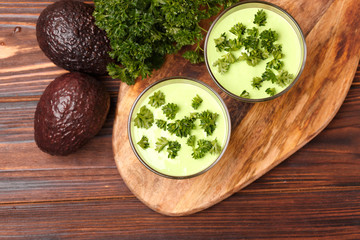 green smoothie with avocado, cucumber, celery and thyme.