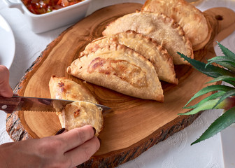 Cutting with a knife Empanadas argentinas traditional food