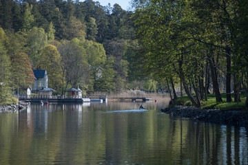 Naklejka premium Landscape view at the waterfront of the lake Lännerstasundet and Stockviken i the district Nacka of Stockholm a sunny spring morning.