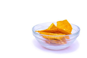 Glass bowl with delicious spicy potato chips isolated on white background.