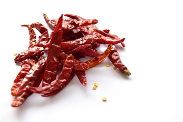
Dried red chillies on a white background
