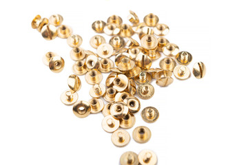 Close-up of a brass screw rivet, for electronics, construction, engineering, Golden metal on a white background.