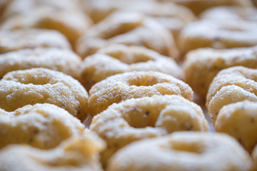 Close up and selective focus of Thai Traditional Style Donut (Kanom Wong), homemade cooking deep fried in round shape tastes sweet and salty. Thai dessert