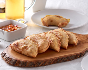 Argentinean empanadas traditional food on wooden ray