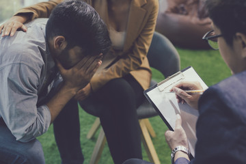 Young couple talking help and giving support by psychiatrist.