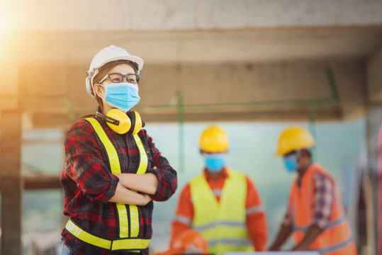 Corona Or Covid-19 Wear Masks During The Design Of Construction. New Normal.Industrial Engineering Team Wears A COVID 19 Protective Mask. Workers Wear A Quarantine Face Mask.