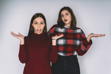 Confused beautiful women shrugging