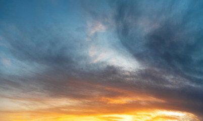 Naklejka na ściany i meble Beautiful bright sunset sky. Dramatic colorful clouds after sunset. Nature backgrounds.