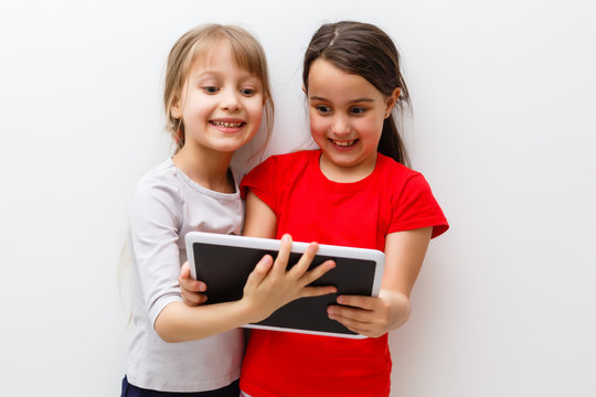 picture of two beautiful girls with tablet pc on white background