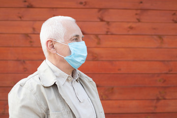 Senior man in protective face mask respirator, outbreak of viral disease coronavirus covid-2019