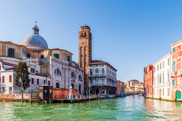 Fototapeta na wymiar Church and building facades on the Grand Canal in Venice in Veneto, Italy