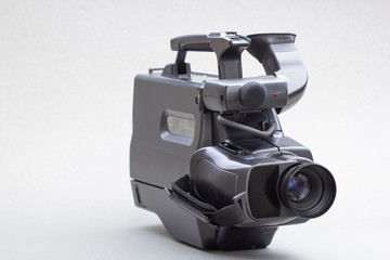 video camera with the microphone isolated on white, in concept of technology, entertainment. Retro...