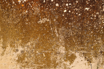 golden irregular weathered granite stone wall surface with moisture and lichen texture - dirty pattern background for a wallpaper