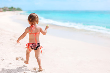 Active little girl at beach having a lot of fun.