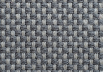Grey textured fabric pattern background.