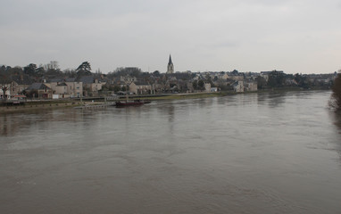 Fototapeta premium Village next to a river in France during winter