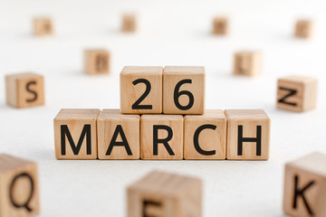 March 26 - from wooden blocks with letters, important date concept, white background random letters around